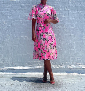 Beautiful neon 1960s floral vintage dress.  SIZE: No label, beset fits S/M    Measures approximately: 19.5" pit to pit / 16" empire waist / 17" waist / 41" length   (Measurements taken laying flat, double where applicable)   MODEL: 5'1, 119lbs, size 4  COMPOSITION: Not listed