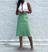 Load image into Gallery viewer, Vintage 1970s Gingham A-line Button Up Skirt By Saks Fifth Avenue. Pinned to fit at the waist. SIZE: Not listed Measures approximately: 27" waist / 21.5" hip / 28" length MODEL: 5'1, 119lbs, size 4 COMPOSITION: Not listed